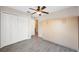 Bedroom with ceiling fan, wood-look floors, and built-in cabinets at 9626 Charlesberg Dr, Tampa, FL 33635