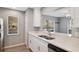 Modern kitchen with white cabinets, stainless steel appliances, and a breakfast bar at 9626 Charlesberg Dr, Tampa, FL 33635