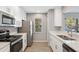 Modern kitchen features stainless steel appliances and white cabinets at 9626 Charlesberg Dr, Tampa, FL 33635