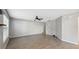 Living room with wood-look floors, gray walls, and a view of the stairs at 9626 Charlesberg Dr, Tampa, FL 33635