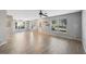 Open living area with neutral walls, wood-look tile, and a ceiling fan at 9626 Charlesberg Dr, Tampa, FL 33635