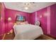 Bedroom with pink walls, queen bed, and ceiling fan at 9790 66Th N St # 130, Pinellas Park, FL 33782