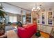 Living room with red couch, built-in shelving, and a chandelier at 9790 66Th N St # 130, Pinellas Park, FL 33782