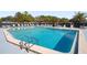 Community pool with plenty of lounge chairs at 9790 66Th N St # 130, Pinellas Park, FL 33782