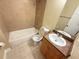 Clean bathroom with tub, toilet, vanity, and tile surround at 21026 Voyager Blvd # 6, Land O Lakes, FL 34638