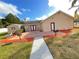 Building exterior featuring a patio area, landscaping, and a shed at 21026 Voyager Blvd # 6, Land O Lakes, FL 34638