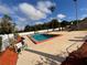 Inviting community pool with lounge chairs and landscaping at 21026 Voyager Blvd # 6, Land O Lakes, FL 34638