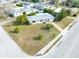 Aerial view of a single-story house with a large front yard and driveway at 1004 Orlando Ave, Bradenton, FL 34207