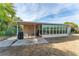 Covered patio with seating area, adjacent to a grassy backyard at 1004 Orlando Ave, Bradenton, FL 34207