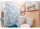 Bright bathroom with a shower/tub combo, updated vanity, and cheerful shower curtain at 1004 Orlando Ave, Bradenton, FL 34207