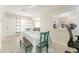 Dining area with a teal bench and chairs, and a view into the kitchen at 1004 Orlando Ave, Bradenton, FL 34207