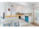 Bright kitchen with white cabinets and a teal dishwasher at 1004 Orlando Ave, Bradenton, FL 34207