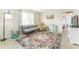 Living room with a gray couch, tan recliner, and patterned area rug at 1004 Orlando Ave, Bradenton, FL 34207