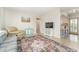 Living room with comfy seating, a TV, and access to kitchen at 1004 Orlando Ave, Bradenton, FL 34207