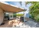 Covered patio with seating area, grill, and view of the backyard at 1004 Orlando Ave, Bradenton, FL 34207