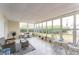 Bright and airy sunroom, furnished with wicker furniture and plants at 1004 Orlando Ave, Bradenton, FL 34207