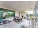 Sunroom with tiled floor, wicker furniture, and large windows at 1004 Orlando Ave, Bradenton, FL 34207