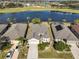 Aerial view of a house with a lake and golf course in the background at 1031 Emerald Dunes Dr, Sun City Center, FL 33573