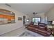 Spacious living room with leather furniture, ceiling fans and lake views at 1031 Emerald Dunes Dr, Sun City Center, FL 33573