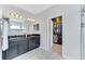 Bathroom with dark vanity, granite countertop and walk-in closet at 10409 Waterstone Dr, Riverview, FL 33578
