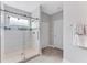 Modern bathroom with a glass shower and pebble floor at 10409 Waterstone Dr, Riverview, FL 33578