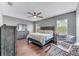 Main bedroom with hardwood floors, ceiling fan and two accent chairs at 10409 Waterstone Dr, Riverview, FL 33578