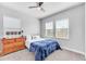 Cozy bedroom with wood dresser and blue bedding at 10409 Waterstone Dr, Riverview, FL 33578