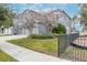 Two-story house with gray siding, two-car garage, and landscaped yard at 10409 Waterstone Dr, Riverview, FL 33578