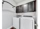 Laundry room with washer, dryer and dark cabinets at 10409 Waterstone Dr, Riverview, FL 33578