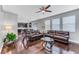 Spacious living room with hardwood floors and dark brown leather sofas at 10409 Waterstone Dr, Riverview, FL 33578