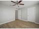 Bright bedroom with hardwood floors, ceiling fan, and double door closet at 10637 Park Meadowbrooke Dr, Riverview, FL 33578