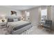 Main bedroom with king-size bed and sitting chair at 10825 Patoka Ter, Parrish, FL 34219