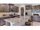 Modern kitchen with dark cabinetry, granite island, and stainless steel appliances at 10825 Patoka Ter, Parrish, FL 34219