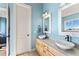 Elegant bathroom with double sinks and light blue walls at 110 Driftwood Ln, Largo, FL 33770