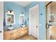 Elegant bathroom with dual sinks and light blue walls at 110 Driftwood Ln, Largo, FL 33770