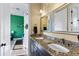 Double vanity bathroom with granite countertop and mirrors at 110 Driftwood Ln, Largo, FL 33770