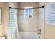 Bright bathroom with shower/tub combo and cheerful blue and green shower curtain at 110 Driftwood Ln, Largo, FL 33770