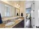 Double vanity bathroom with granite countertop and view into bedroom at 110 Driftwood Ln, Largo, FL 33770