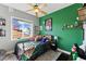 Cozy bedroom with green accent wall and water views at 110 Driftwood Ln, Largo, FL 33770