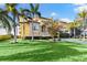 Beautiful two-story house with palm trees and a nicely landscaped lawn at 110 Driftwood Ln, Largo, FL 33770