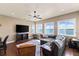 Spacious living area features stunning water views and large TV at 110 Driftwood Ln, Largo, FL 33770