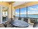 Screened patio with outdoor dining set and breathtaking water views at 110 Driftwood Ln, Largo, FL 33770