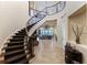Impressive curved staircase with ornate railing and dark carpeting at 110 Driftwood Ln, Largo, FL 33770