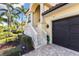 Elegant staircase with stone steps and ornate railing leading to the house entrance at 110 Driftwood Ln, Largo, FL 33770