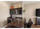 Home bar with granite countertop, wine storage, and liquor shelving at 110 Driftwood Ln, Largo, FL 33770