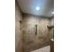 Large walk-in shower with marble tile and built-in shelving at 1100 N Shore Ne Dr # 403, St Petersburg, FL 33701