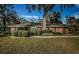 Brick ranch home with a large front yard, mature landscaping, and a spacious walkway at 118 Laurel Tree Way, Brandon, FL 33511