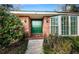 Green front door entry to brick home with landscaping at 118 Laurel Tree Way, Brandon, FL 33511