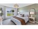 Spacious primary bedroom with a king-size bed and accent wall at 17347 Wheatberry Blvd, Parrish, FL 34219