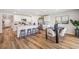 Open concept kitchen with an island, white cabinets, and hardwood floors at 17347 Wheatberry Blvd, Parrish, FL 34219